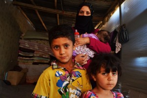 Ratiba Awad pictured with her three children, Ouday, Ahraa, and Batoula (5 years, 4 years, and 7 months old resepctively). They live in an old cow shed with 20 other Syrian refugees who were also forced to abandon their homes during the Syrian war. Source: Trocaire