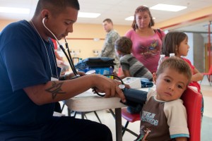 Ruperto Peña receives a blood pressure test from a local Rio Grande Firefighter during Operation Lone Star at Ringgold Middle School in Rio Grande City, Texas, July 30, 2013. Operation Lone Star serves as the only access many residents in the South Texas Border Region have to medical care or doctors.  Available services included immunizations, diabetic and blood pressure screenings, hearing and vision exams, sports physicals and dental services. (U.S. Army National Guard photo by Army Spc. Aaron Moreno) 130730-Z-QF937-369